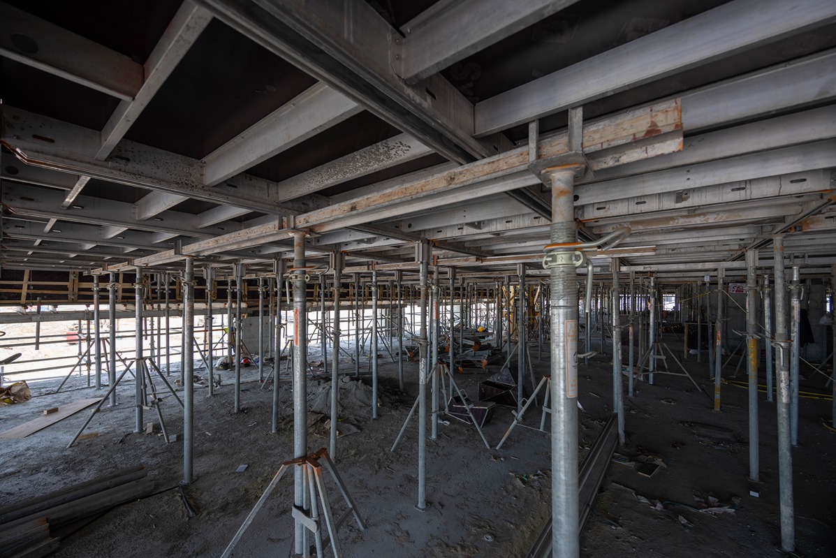 Beach Walk Iii By Imtiaz An industrial construction site featuring metal scaffolding and beams, with equipment and materials scattered on the ground.